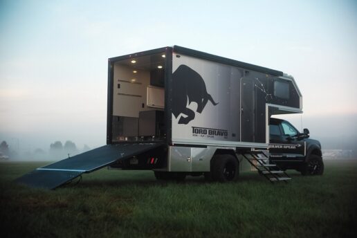 A picture of Toro Bravo 4x4's Silver Spear exterior, with its rear ramp down and parked in a field.