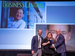 A picture of Dan Pearson's daughter, Whitney, accepting her late father's RVDA Titan Award from chairman Nathan Hart and President Phil Ingrassia.