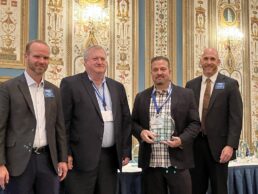 A picture of (L to R) RVDA outgoing chairman Nathan Hart, East to West GM Eric Sharp, East to West GM Todd Grubb and incoming RVDA chairman Ryan Horsey as East to West is presented its Quality Circle Award.