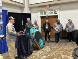 A picture of Keller Marine & RV reps and vendor sales rep together to learn about new products available to order at the 2023 show.