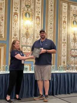 A picture of Lightspeed presenting an RECT award to Bish's RV during the 2023 RVDA Convention/Expo.