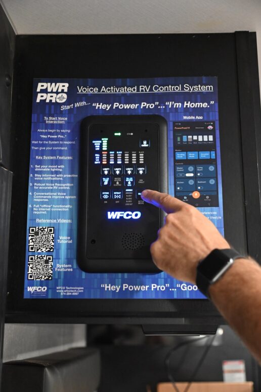A picture of a hand interacting with WFCO Technologies' "Power Pro" digital control system.