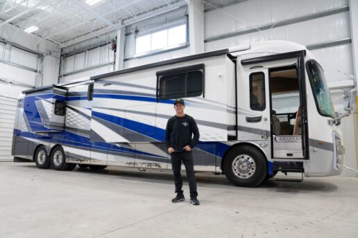 A picture of Brian Deegan with his new Entegra Coach. 