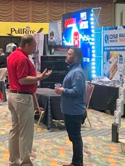 A picture of attendees near exhibits at the Northern Wholesale Supply show.