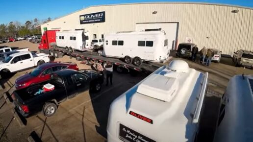 A screenshot of a video of Oliver Travel Trailer's first RVs being shipped to a dealership.
