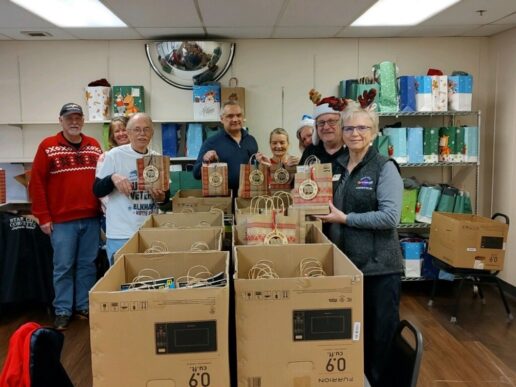 A picture of Venture RV Plant 8 employees organizing gift bags.