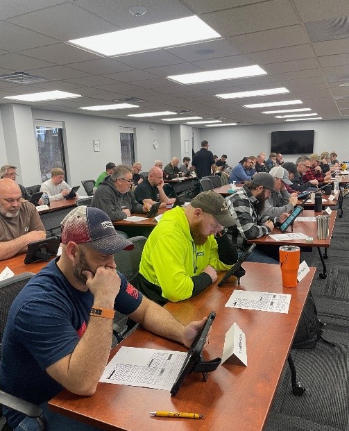A picture of Newmar technicians taking an exam at the RVTI headquarters.