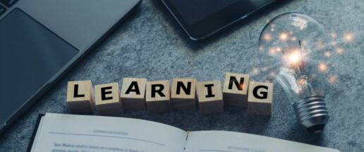 A picture of the word 'learning' spelled out next to a lightbulb.