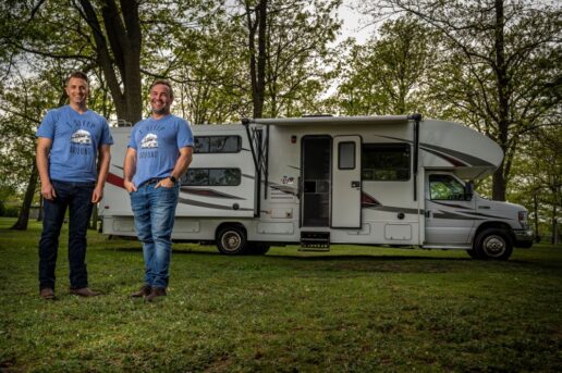 A picture of RVezy founders next to a motorhome.