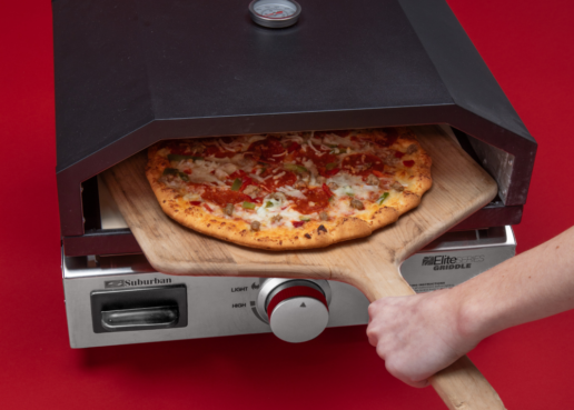 A picture of a pizza cooking in Suburban's 18-inch pizza oven Elite Series Griddle.
