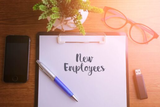 A picture of "new employees" written on a clipboard.