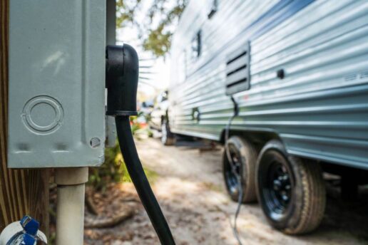 A picture of an RV shore power cable plugged into a campground pedestal.