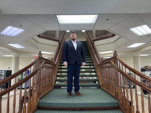 A picture of the new RV/MH Hall of Fame president Daryll Milnikel standing on stairs