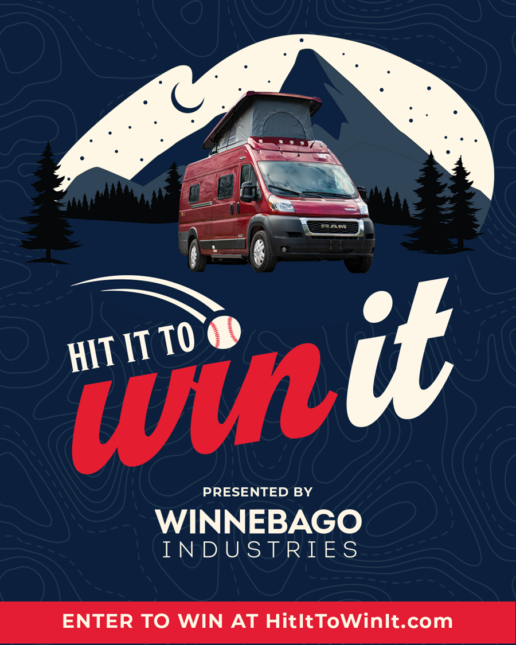 A picture of the poster for Winnebago's Hit It To Win It baseball sweepstakes, featuring an RV set in front of a mountain with the moon rising behind it.
