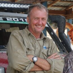 A picture of Lance Gillies, founder of EarthCruiser, standing in front of a vehicle.
