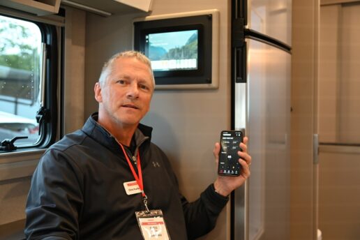 A picture of Winnebago's Chris Kuelbs with the Winnebago Connect mobile app on his phone.