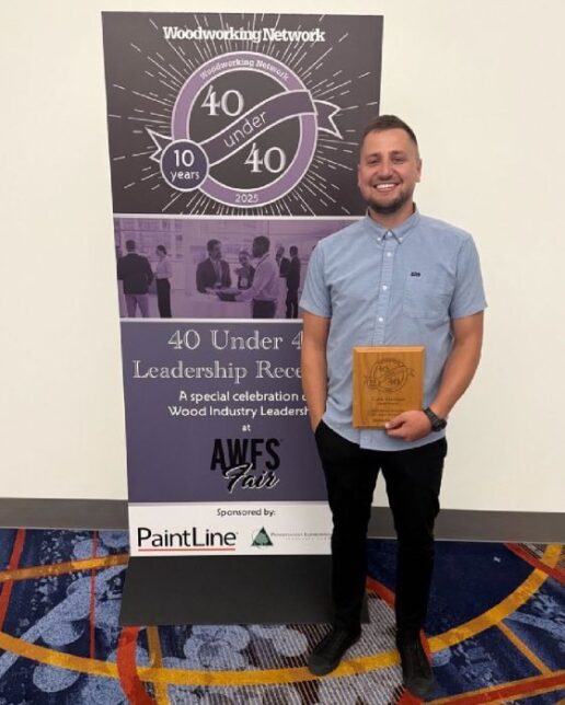 A photo of Cody Harman receiving his Wood Industry 40 Under 40 award.