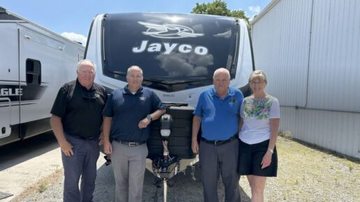 A photo of a Jayco trailer with representatives from Reineke RV and Fortman's Auto and RV.