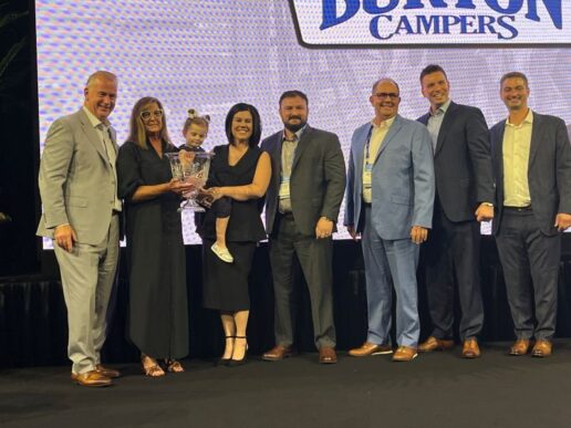 A photo of the Burton family from Burton Campers accepting the Founder's Award at the 2025 Jayco Dealers Homecoming.