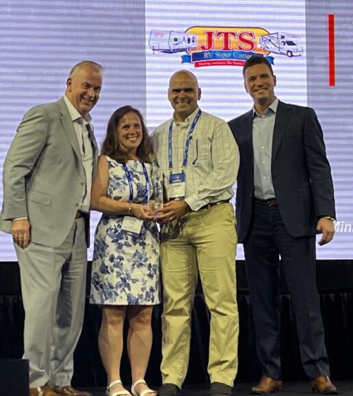 A photo of Jim's Trailer Sales accepting its award as the highest-rated Customer Satisfaction Index towable dealer for Jayco.