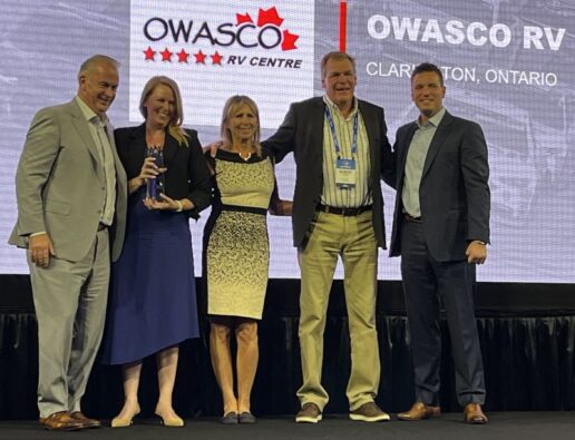 A photo of Owasco RV of Clarington, Ontario, receiving Jayco's Customer Satisfaction Index award as the top motorized dealer.
