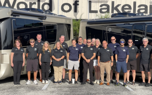 A photo of personnel from Gerzeny's RV World of Lakeland in front of Leisure Travel Vans.