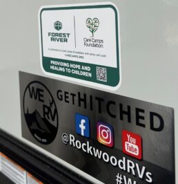 A photo of the Forest River and Care Camps Foundation cobranded decal.