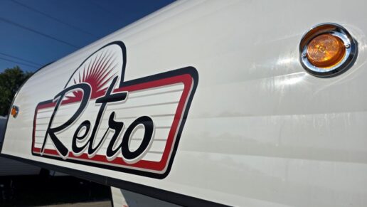 A closeup photo of the Retro brand logo on the exterior of an RV.
