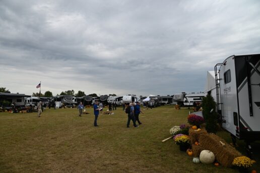 A photo of attendees walking around a Grand Design RV showcase.