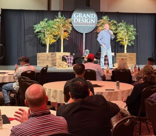 A photo of Grand Design RV President and CEO Don Clark addressing the motorized Grand Design University.