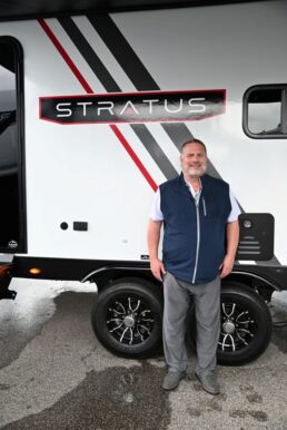 A photo of Venture RV General Manager Dave Boggs in front on a Venture Stratus travel trailer.
