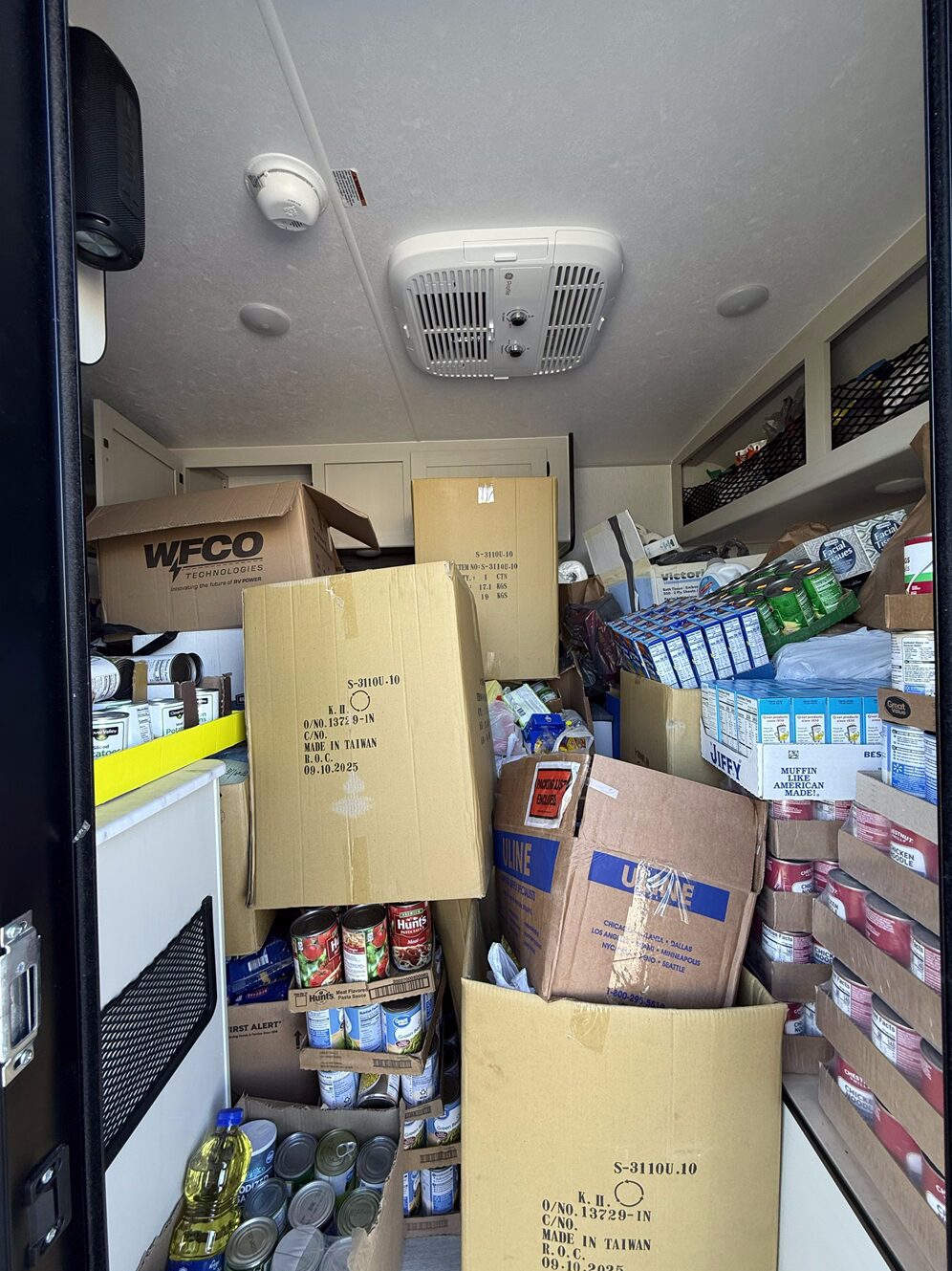 A picture of a Coachmen RV Remote travel trailer filled with non-perishable food and other supplies collected during the company's annual food drive.