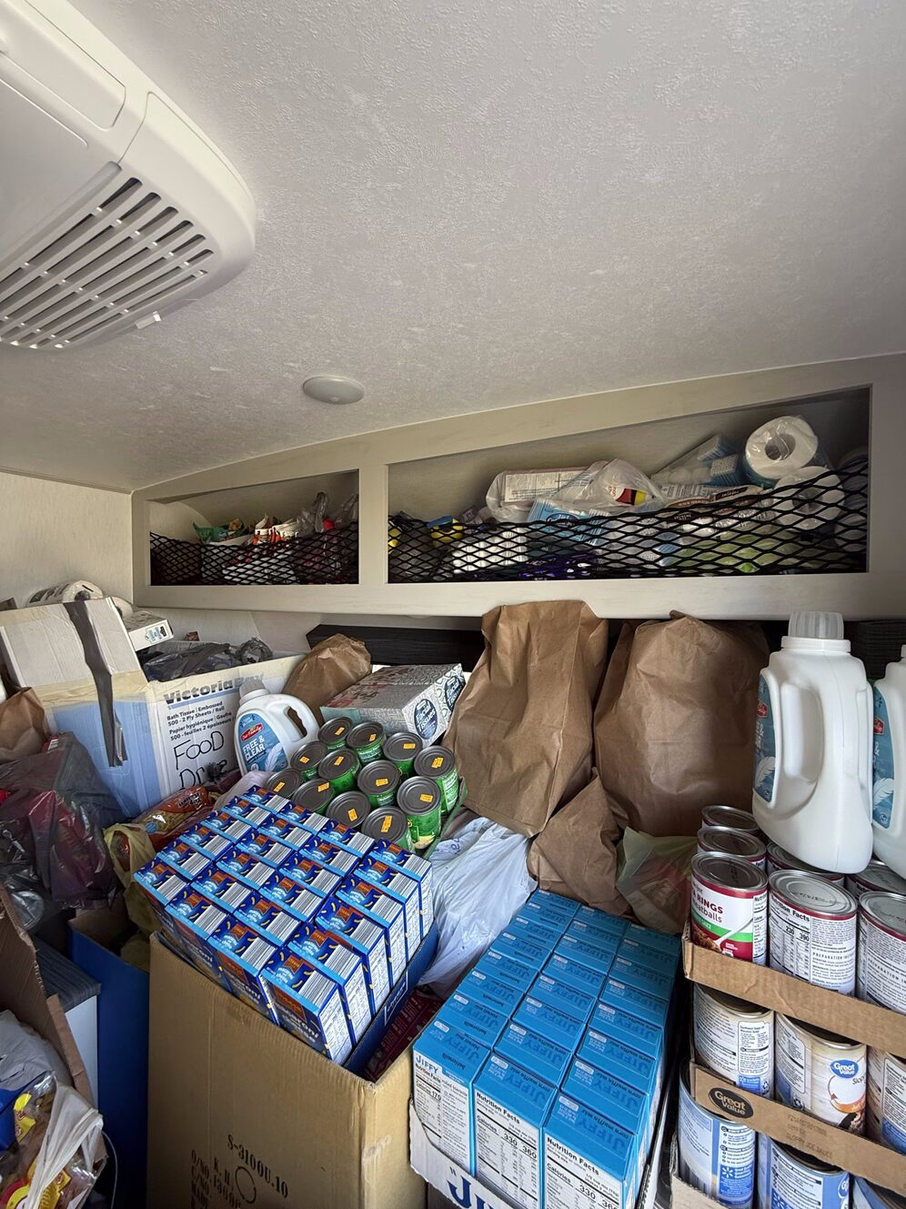 A picture of a Coachmen RV Remote travel trailer filled with non-perishable food and other supplies collected during the company's annual food drive.