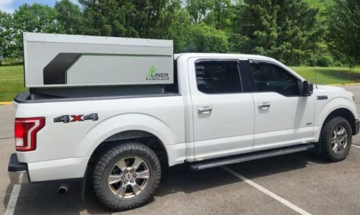 A photo of the Aliner Switchback trunk camper in the back of a pickup truck.