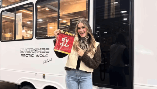 A photo of influencer Leah Goodrich in front of the fifth wheel design she collaborated on with Cherokee.