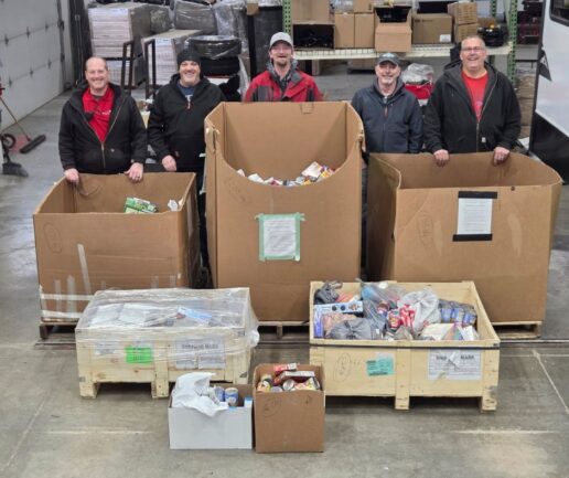 A photo of East to West RV employees with the food donations they collected this holiday season.