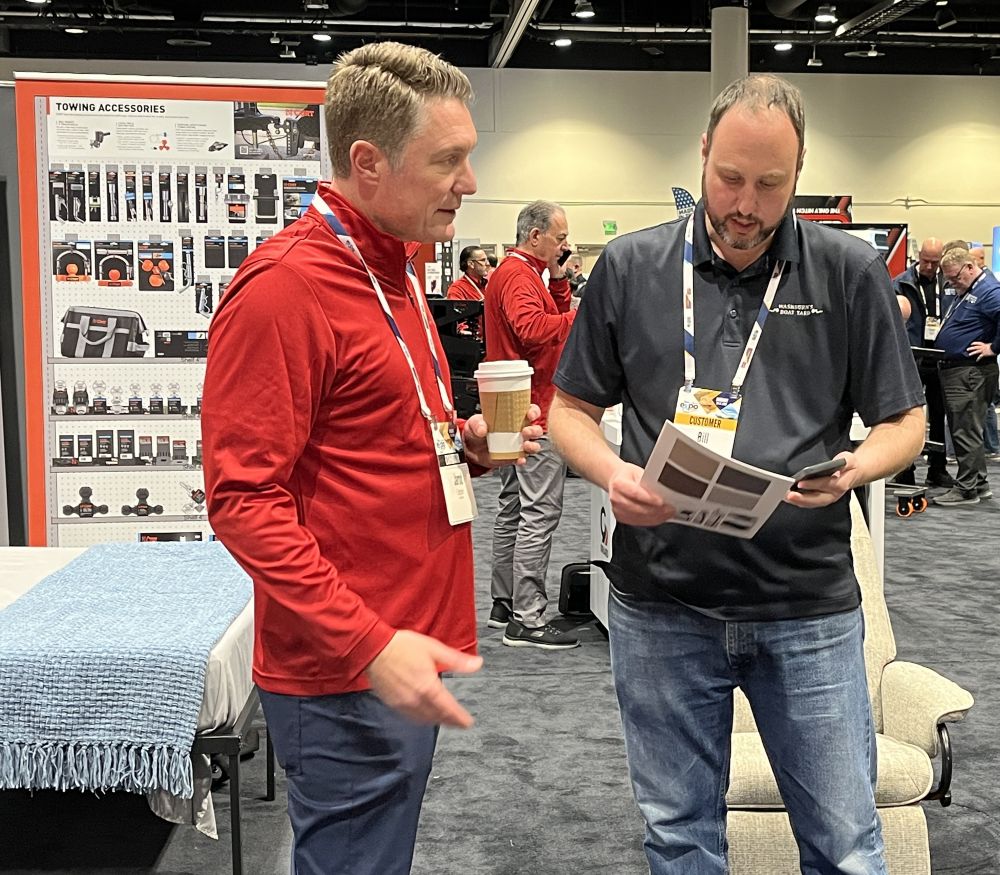 A photo of Jarod Lippert and Bill Brandon in the Lippert booth at the NTP-Stag Expo.