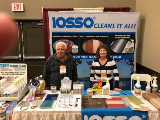 A photo of the Iosso Products Vice President Marianne Ortmann standing with her father at the Iosso Products booth at the Land and Sea show in Wisconsin.