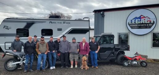 A photo of the Legacy Power Sports & RV staff in front of their new building and some of the products they sell.