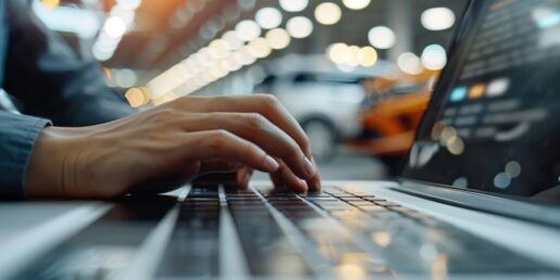 A stock image of a hand on a laptop computer keyboard, possibly accessing or logging into an online portal.