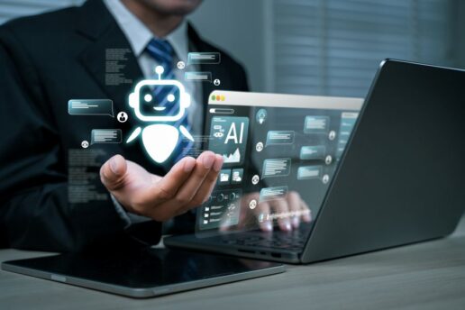 A stock photo of a man using a computer with digital graphics indicating AI assistance.